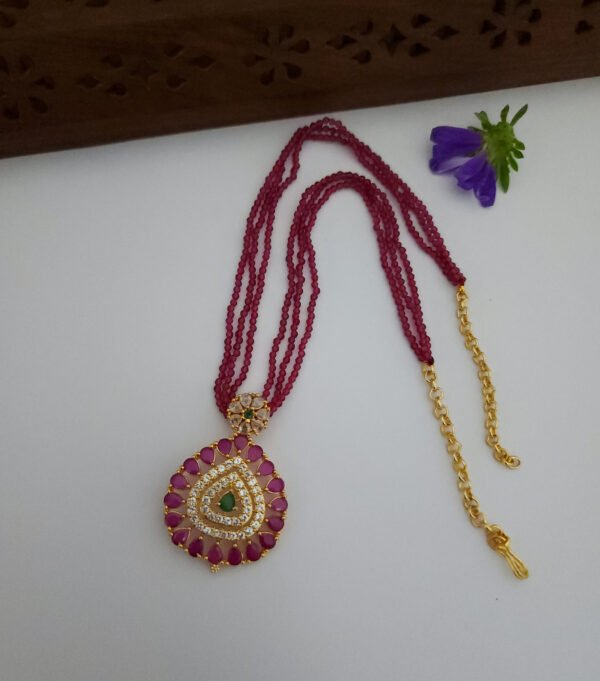 Ruby Spinner With Multi Colored Pendent